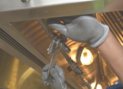 Plumber with wrench tightening pipe