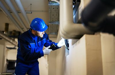 Commercial plumber from Mr Perfect Plumbing inspecting pipes