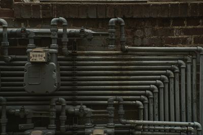 Series of gas pipes and gauage hooked up to the exterior of a building