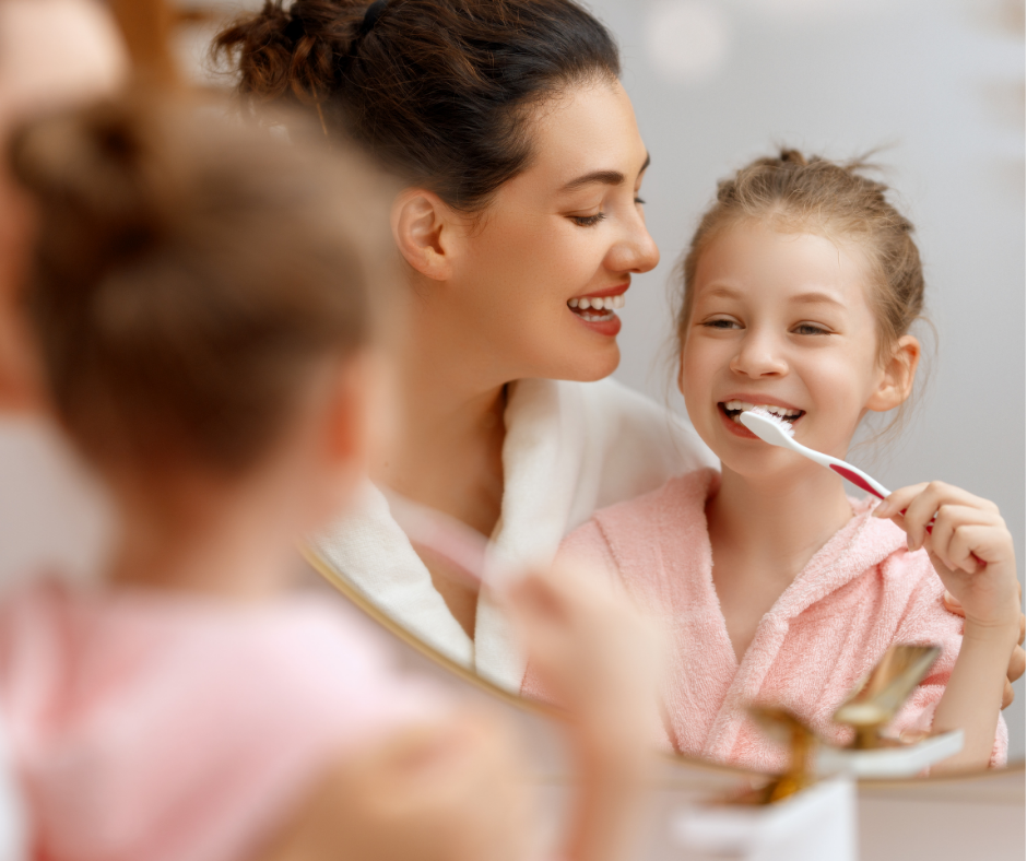 Small child brushing teeth at the bathroom sink.
