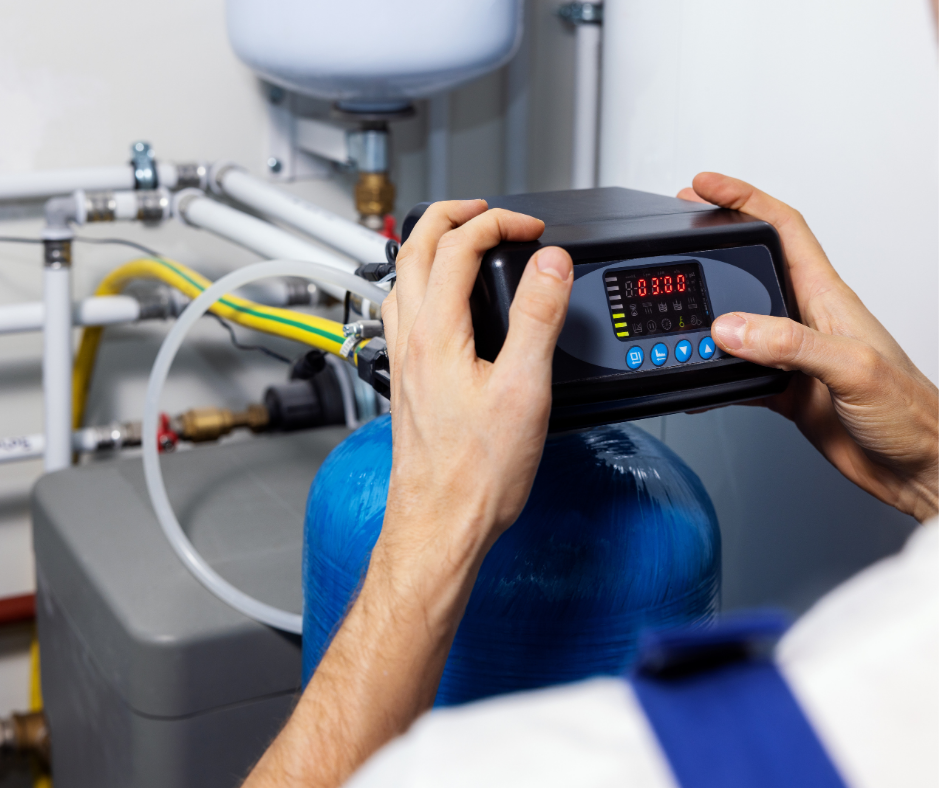  Plumber installing a whole-home water filtration system.